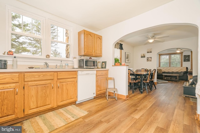 kitchen featuring light hardwood / wood-style flooring, sink, white dishwasher, and ceiling fan