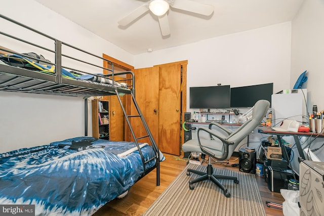 bedroom with wood-type flooring and ceiling fan