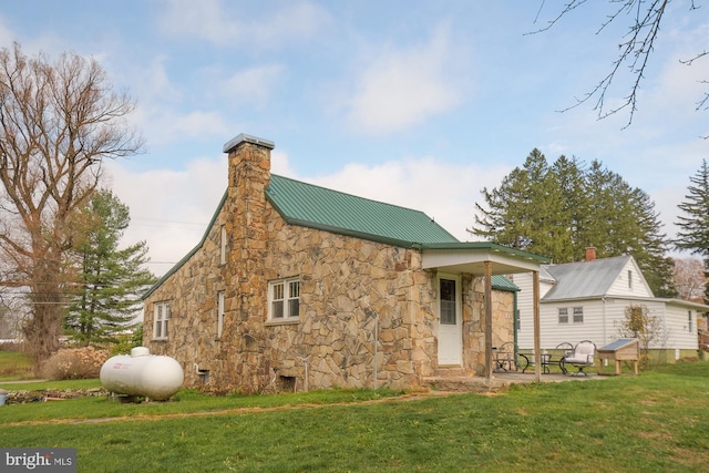 117 Accident Bittinger Rd, Accident, MD 21520 - back of house featuring stone siding, a yard, a chimney, metal roof, and a standing seam roof