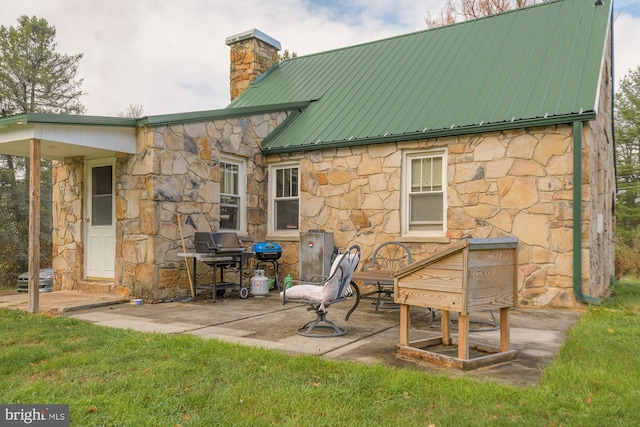 back of house featuring a yard and a patio