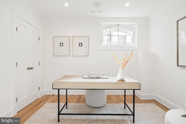 office area with ornamental molding and light wood-type flooring