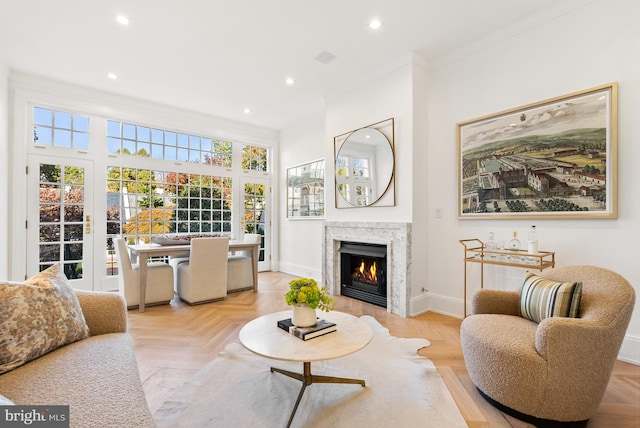 living room featuring ornamental molding and light parquet flooring