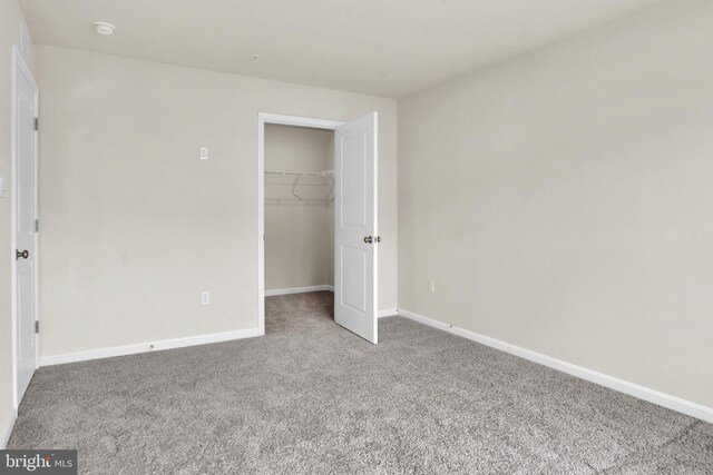 unfurnished bedroom with a closet and carpet floors