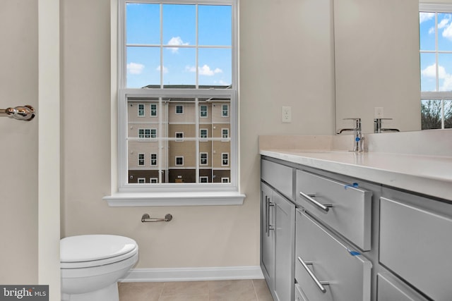 bathroom with vanity, toilet, and tile patterned flooring