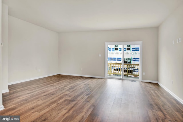 unfurnished room with hardwood / wood-style flooring