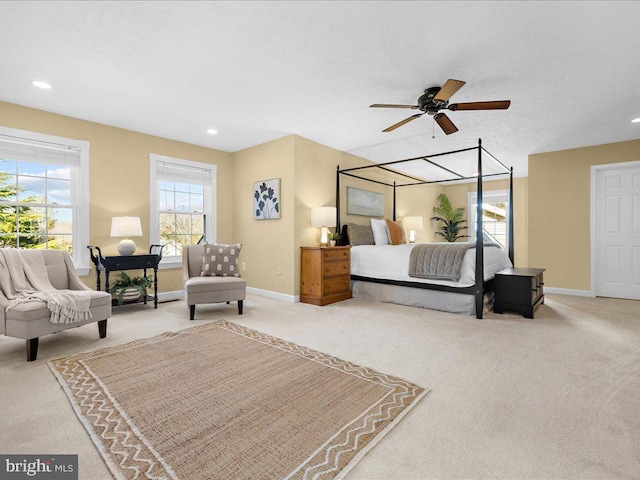 bedroom with recessed lighting, light colored carpet, and baseboards