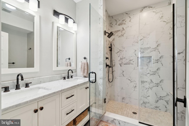 bathroom featuring vanity and an enclosed shower