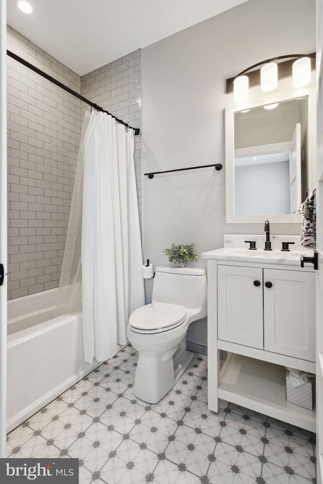 full bathroom featuring vanity, shower / tub combo with curtain, and toilet