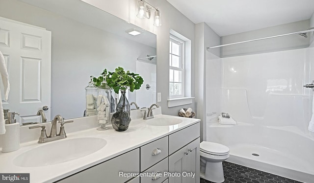 bathroom featuring walk in shower, toilet, vanity, and tile patterned floors