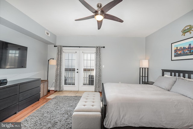 bedroom featuring access to exterior, ceiling fan, french doors, and light wood-type flooring