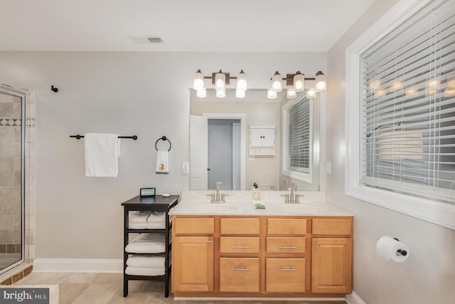 bathroom with tile patterned floors, vanity, and an enclosed shower