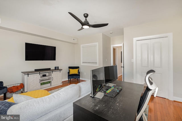 living room featuring hardwood / wood-style flooring and ceiling fan