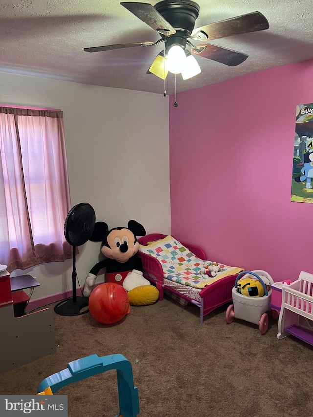 carpeted bedroom with a textured ceiling and ceiling fan