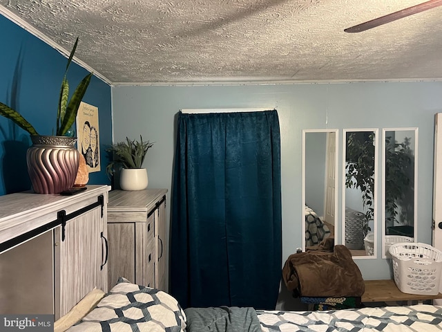 bedroom with hardwood / wood-style flooring, ceiling fan, a textured ceiling, and crown molding