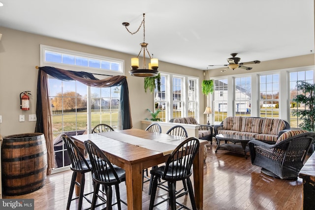 dining room with ceiling fan and dark wood-type flooring