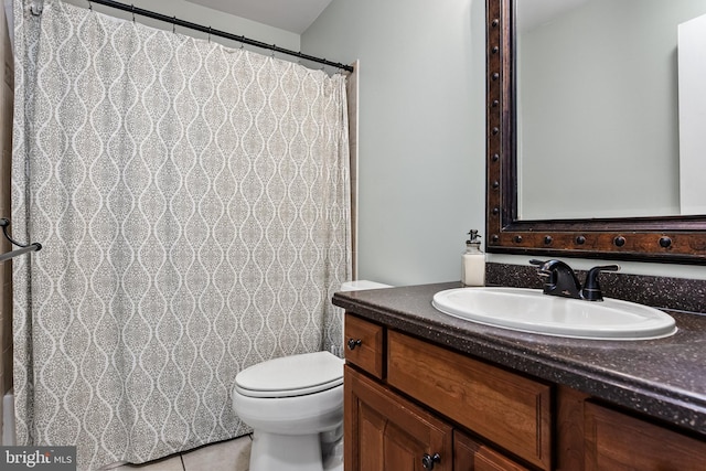 bathroom with tile patterned floors, vanity, and toilet