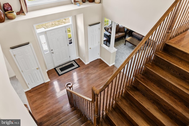 foyer entrance featuring plenty of natural light and hardwood / wood-style flooring