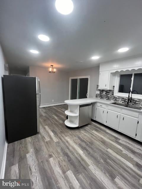 kitchen with sink, white cabinetry, kitchen peninsula, and appliances with stainless steel finishes