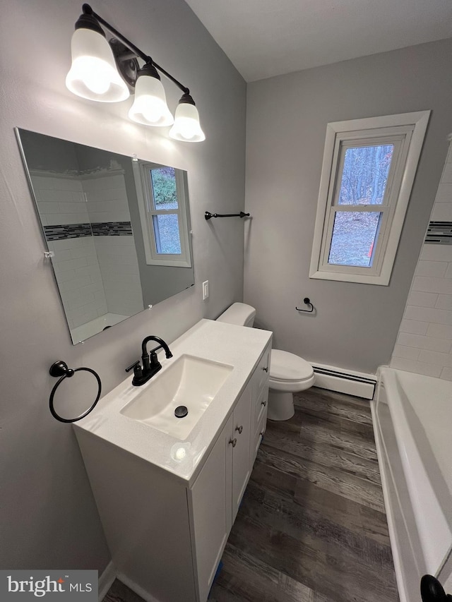 bathroom with baseboard heating, vanity, toilet, and hardwood / wood-style flooring