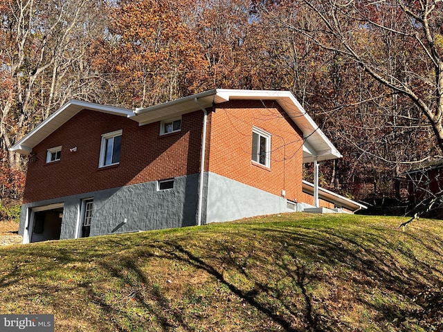 view of home's exterior featuring a garage and a lawn