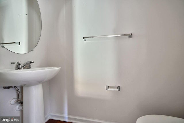 bathroom featuring toilet and hardwood / wood-style flooring