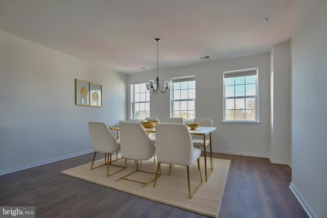 dining room with a chandelier and dark hardwood / wood-style floors