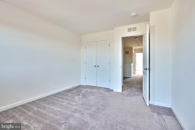 unfurnished bedroom with a closet and carpet