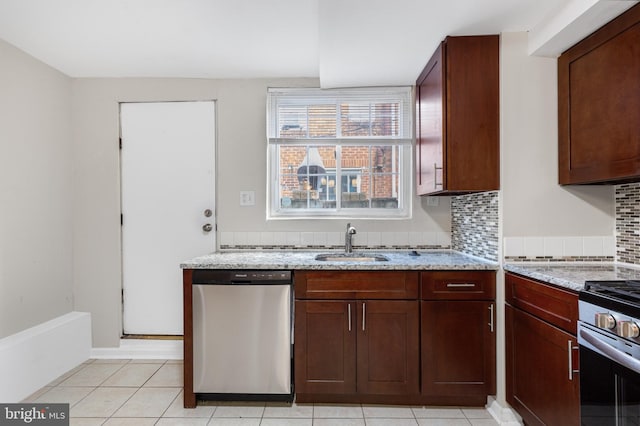 kitchen featuring decorative backsplash, appliances with stainless steel finishes, sink, and light stone counters