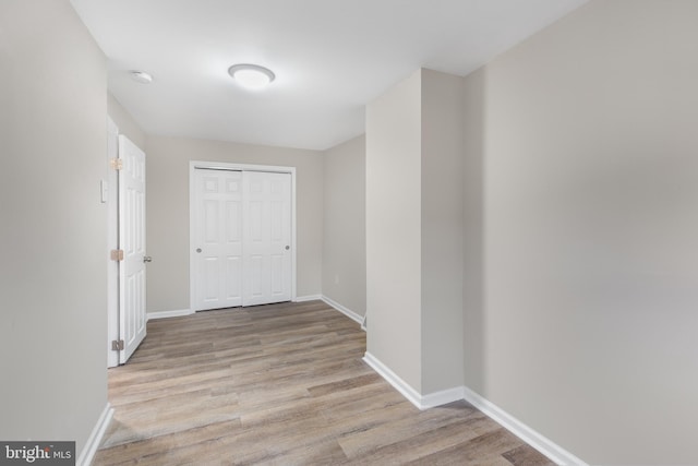 corridor with light hardwood / wood-style flooring