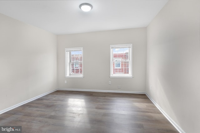 spare room featuring dark hardwood / wood-style floors