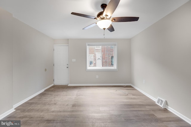 spare room with ceiling fan and light hardwood / wood-style floors