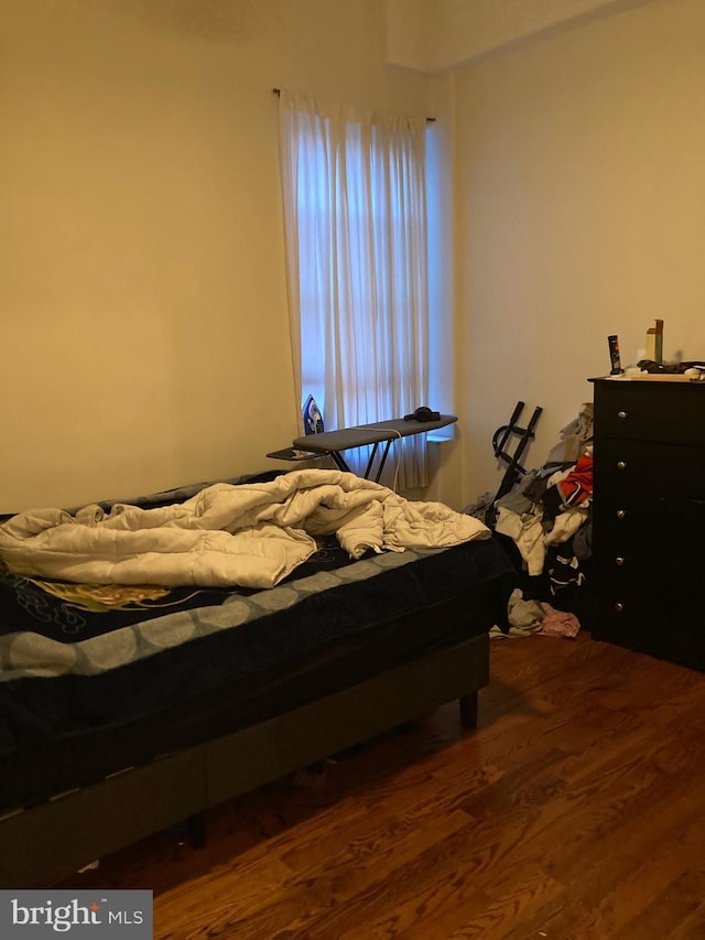 bedroom featuring dark hardwood / wood-style flooring