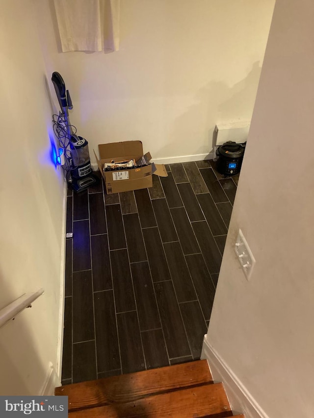 laundry room with dark wood-type flooring