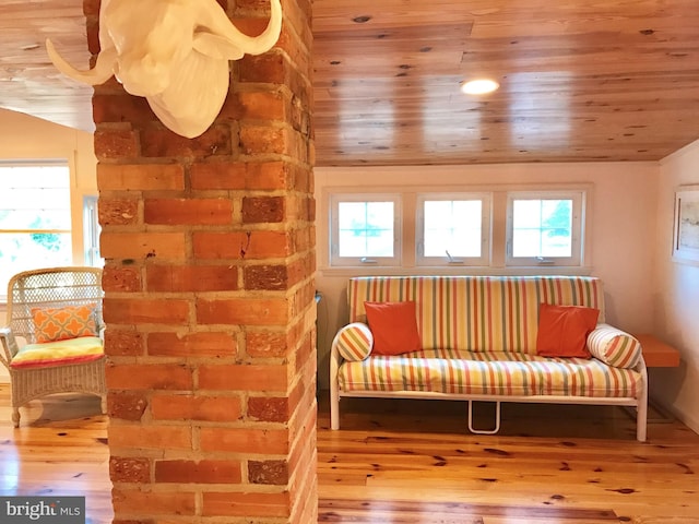 sitting room with hardwood / wood-style flooring, a healthy amount of sunlight, and wood ceiling