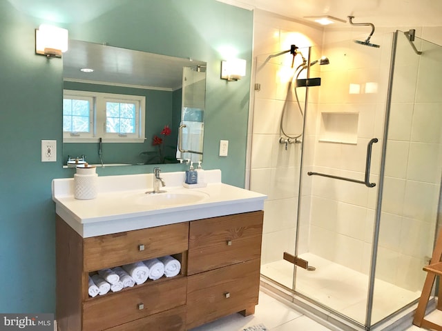 bathroom featuring vanity, tile patterned floors, walk in shower, and crown molding