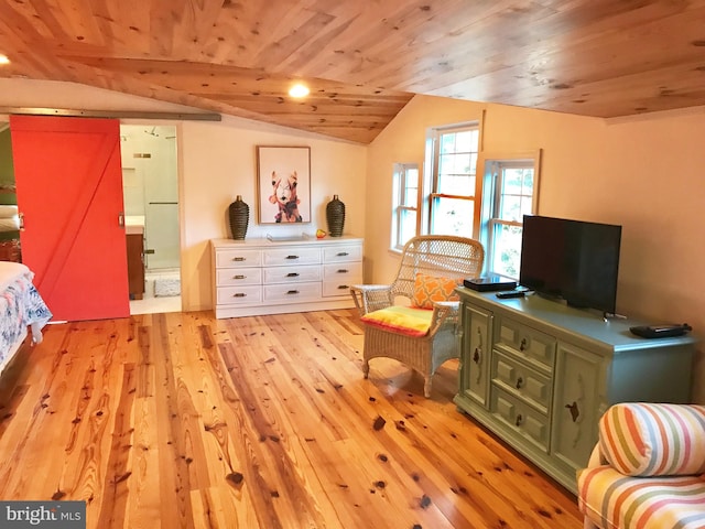 living area with lofted ceiling with beams, a barn door, wooden ceiling, and light hardwood / wood-style flooring