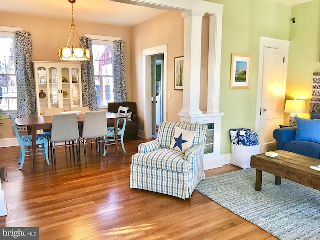 sitting room with hardwood / wood-style floors and a chandelier