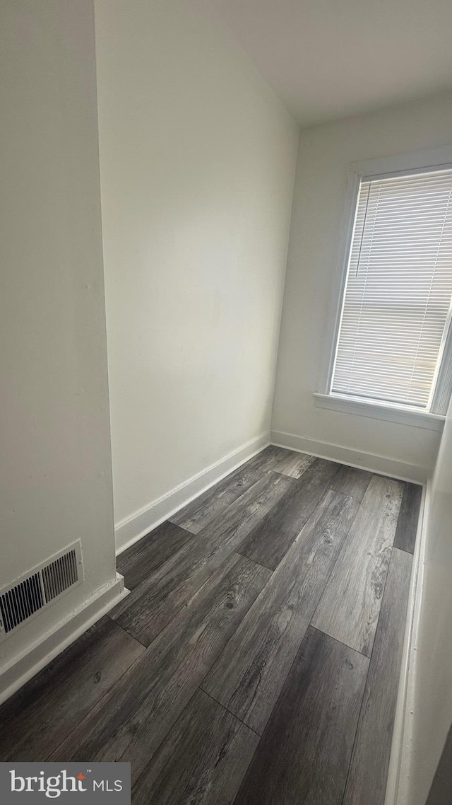 unfurnished room featuring dark hardwood / wood-style flooring