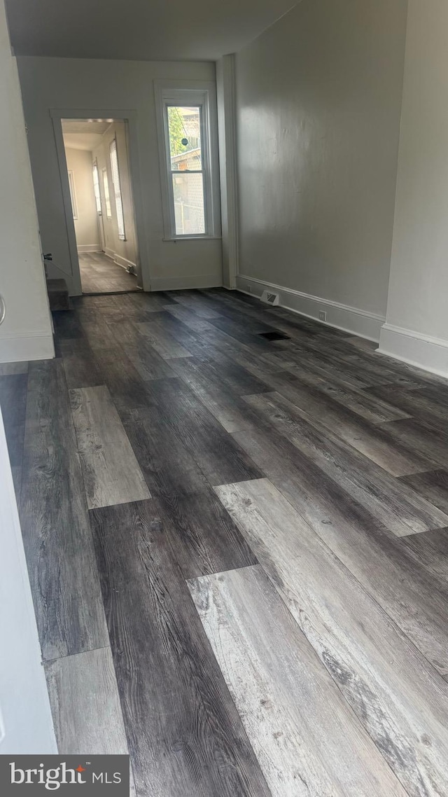 spare room featuring dark hardwood / wood-style floors