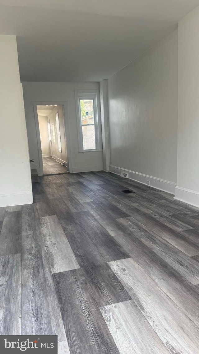 empty room with dark hardwood / wood-style floors