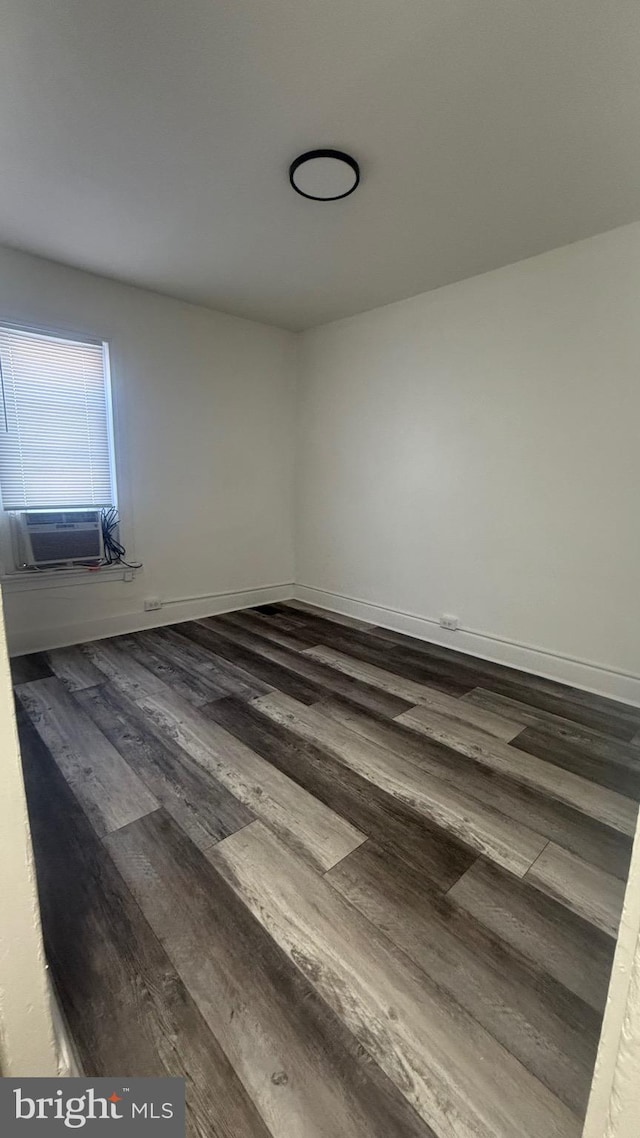 spare room featuring cooling unit and wood-type flooring