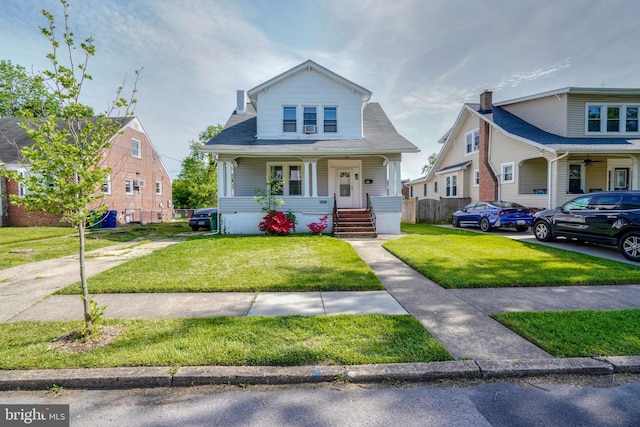 bungalow-style house with a front yard and a porch