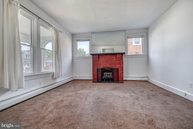 unfurnished living room featuring carpet, a brick fireplace, and baseboard heating