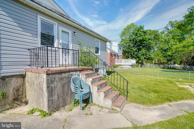 doorway to property with a yard