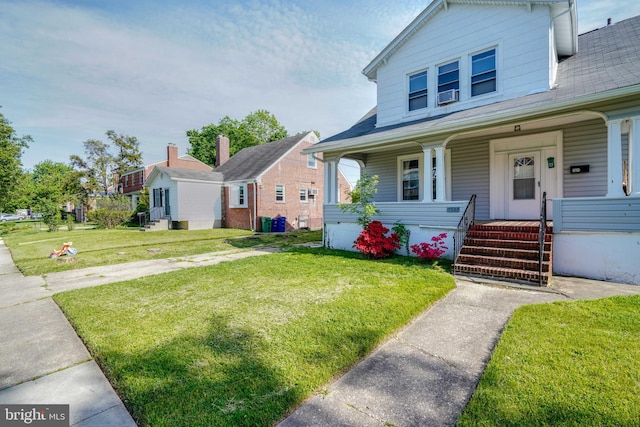 bungalow-style house featuring covered porch and a front yard