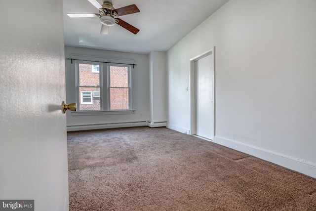 spare room featuring ceiling fan, a baseboard heating unit, and carpet floors