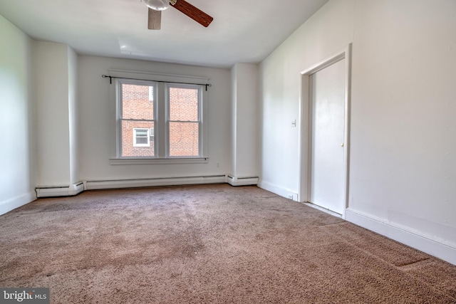 carpeted empty room with baseboard heating and ceiling fan