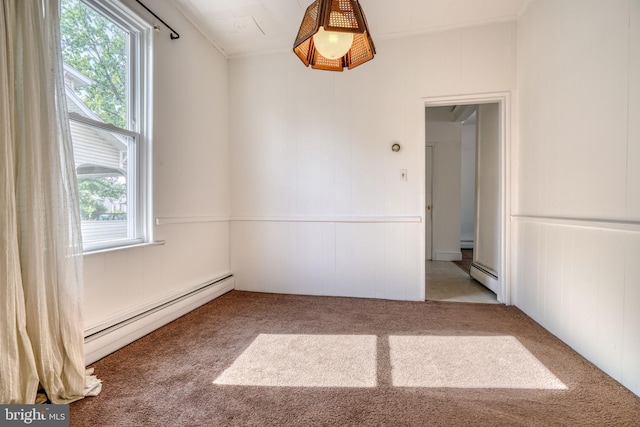 carpeted empty room with baseboard heating and plenty of natural light