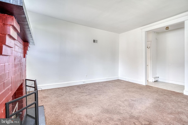 carpeted empty room featuring a baseboard radiator