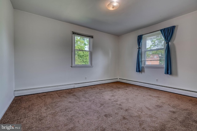 unfurnished room featuring a baseboard heating unit, carpet flooring, and a wealth of natural light